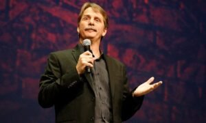 Jeff Foxworthy smiling during a comedy performance, highlighting his successful career, net worth, wife, family, and biography in 2026.