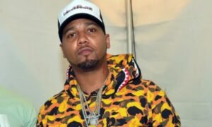 Juelz Santana performing live on stage during a hip-hop concert, highlighting his successful music career and estimated 2026 net worth.